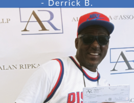 Alan Ripka & Associates Happy Client with settlement check