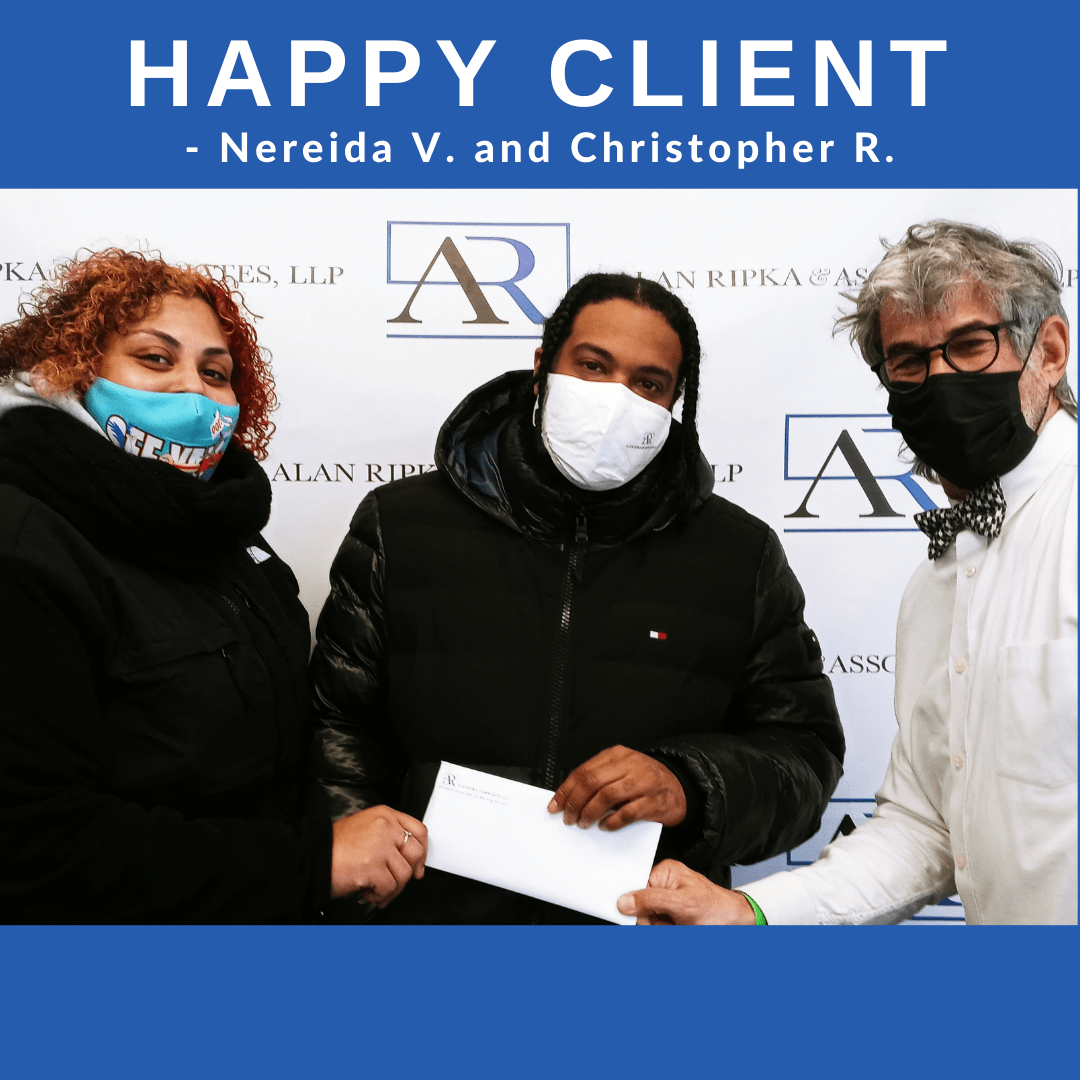 Happy clients get settlement check at Alan Ripka and Associates